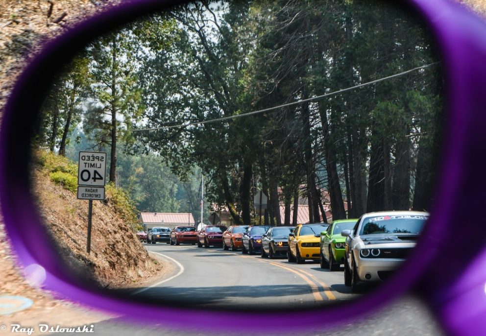 vehicles driving down the road in a line