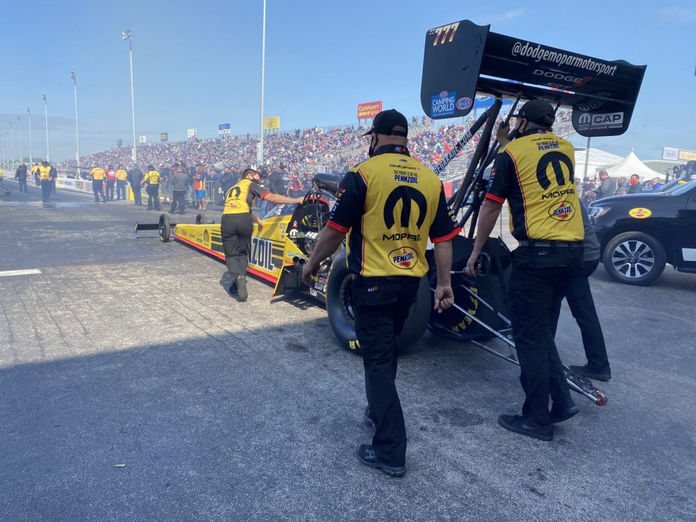 Leah's crew pushing car to the start line