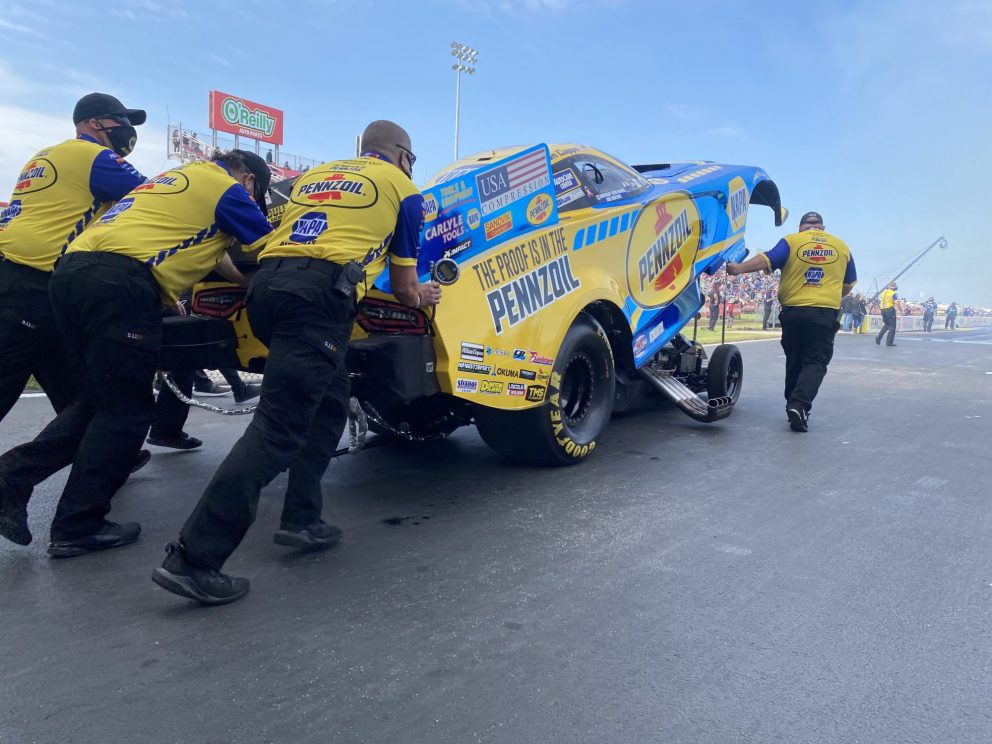 Matt Hagan's crew pushing his funny car to the start line