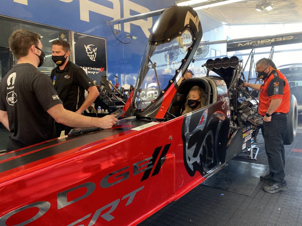 Leah Pruett sitting in her top fuel dragster