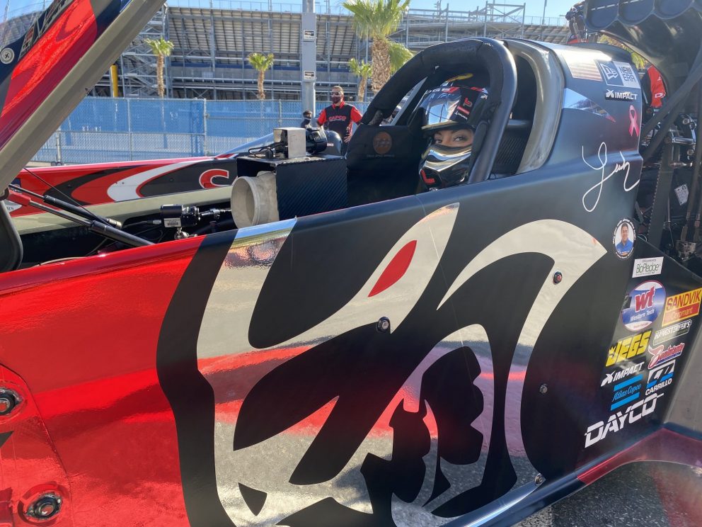 Leah Pruett sitting in her top fuel dragster