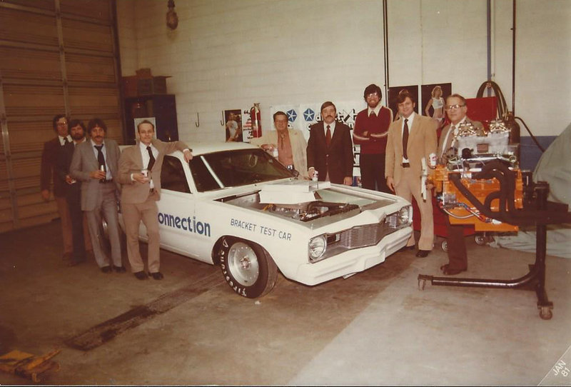 Larry Henry posing beside a Direct Connection bracket test car