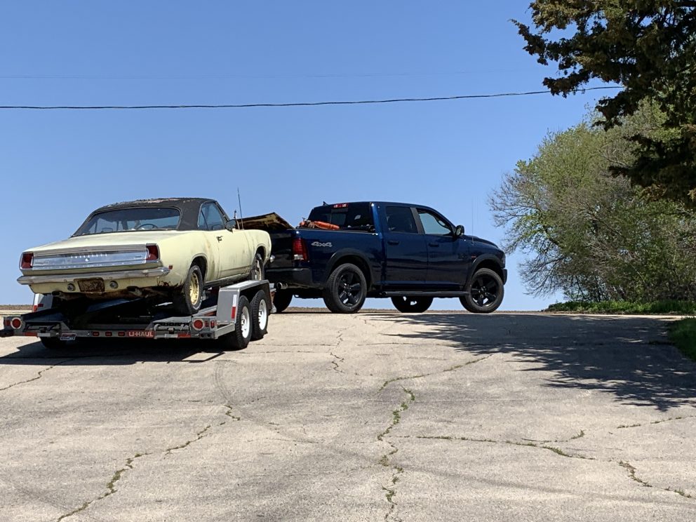 Millenial Mopar Owner -Vehicle on trailer being towed up a hill.