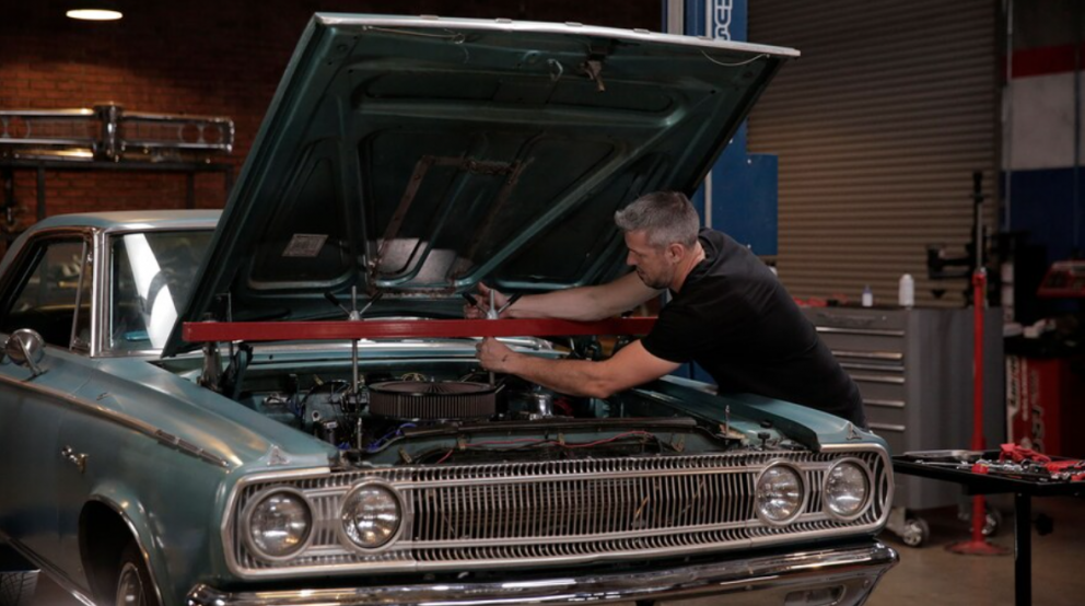 man working on his 1965 Dodge Coronet