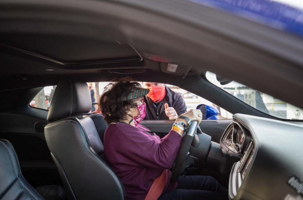 Woman receiving driving instruction in the driver's seat