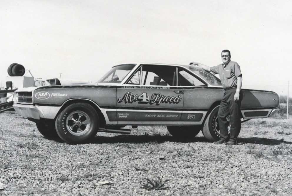 Herb standing next to his race car