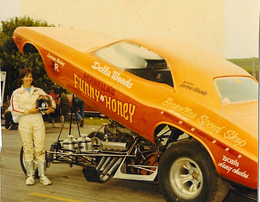 Della Woods posing with her funny car