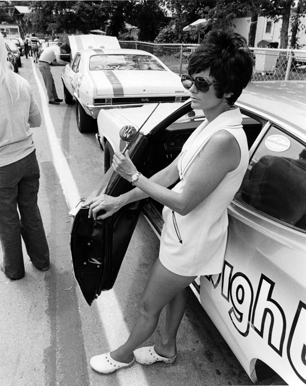 Judy Lilly standing outside of her drag car in the staging lanes