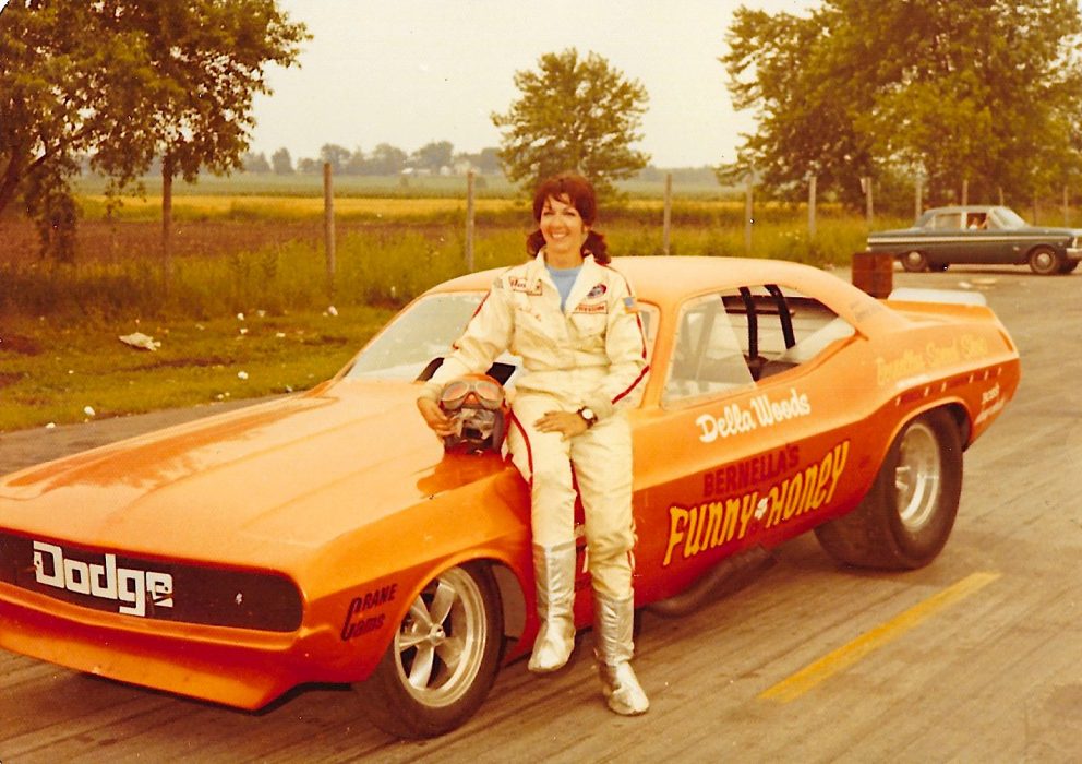 Della Woods posing with her race car