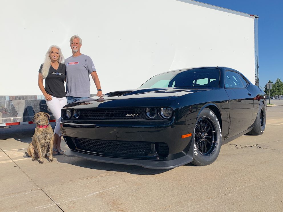 Geoff Turk and his wife standing next to his Drag Pak