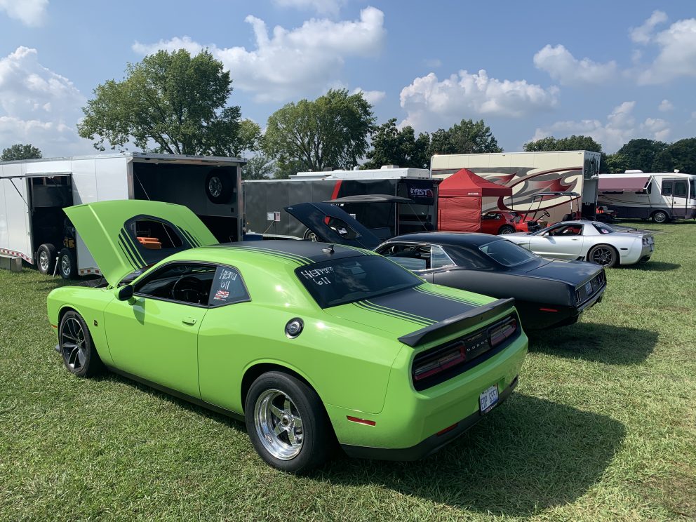 Challenger and other cars in the pit area of a drag race