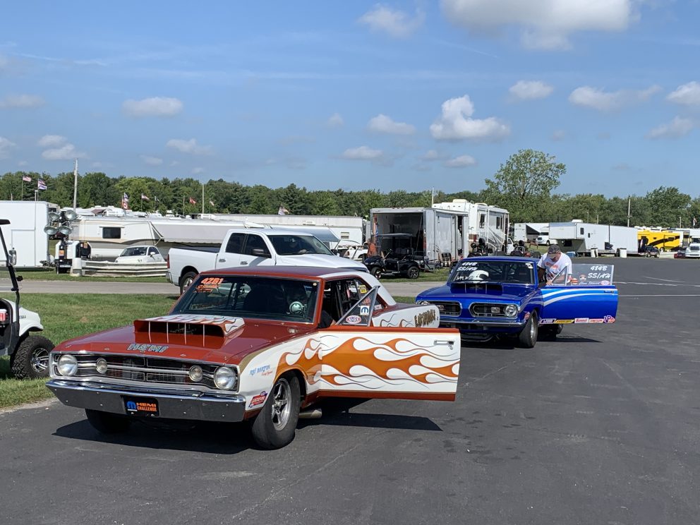 vintage cars getting ready to drag race