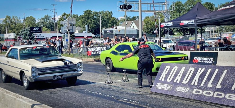 Two cars drag racing at Roadkill Nights Powered by Dodge
