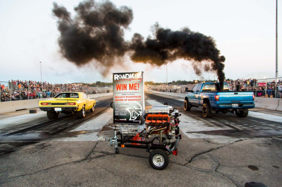 two cars drag racing at Roadkill Nights Powered by Dodge