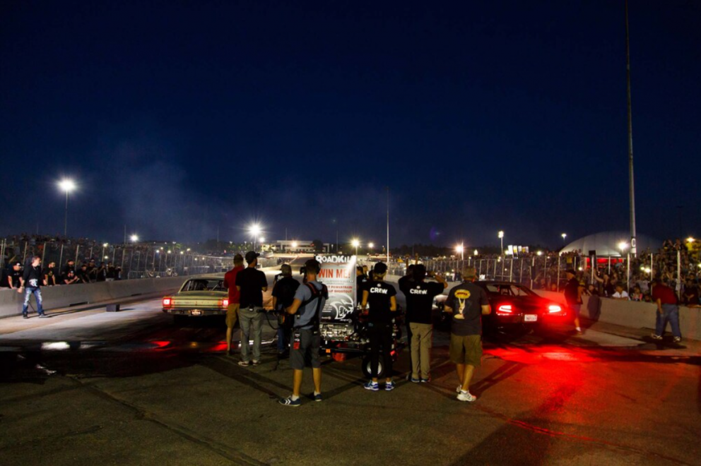 two cars drag racing at Roadkill Nights Powered by Dodge