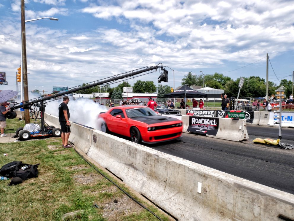 Challenger drag racing on Woodward during Roadkill Nights Powered by Dodge