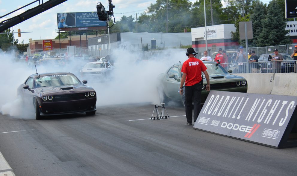 Two cars doing burnouts prior to racing at Roadkill Nights Powered by Dodge