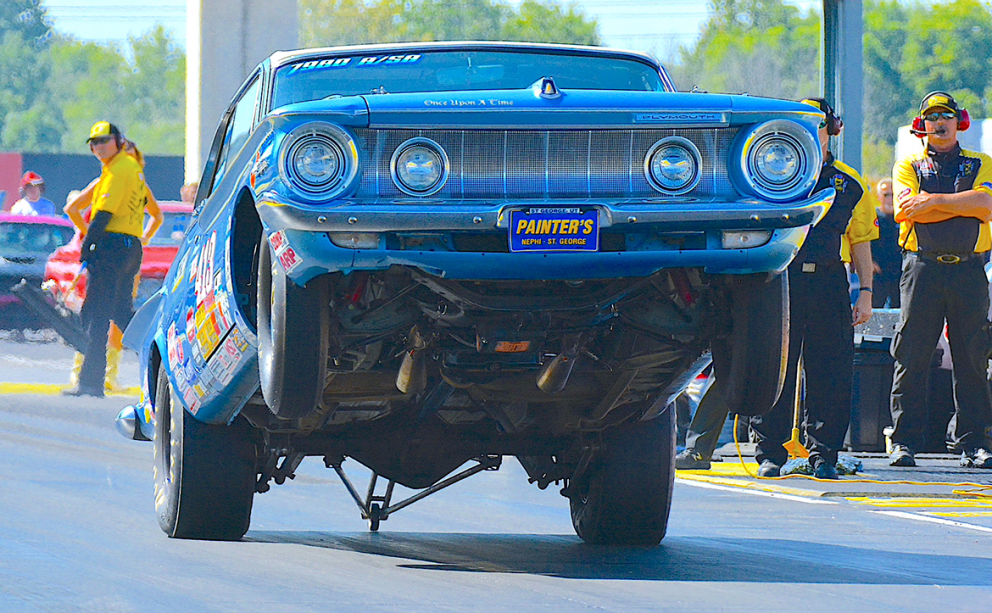 Vehicle on two wheels racing down a drag strip