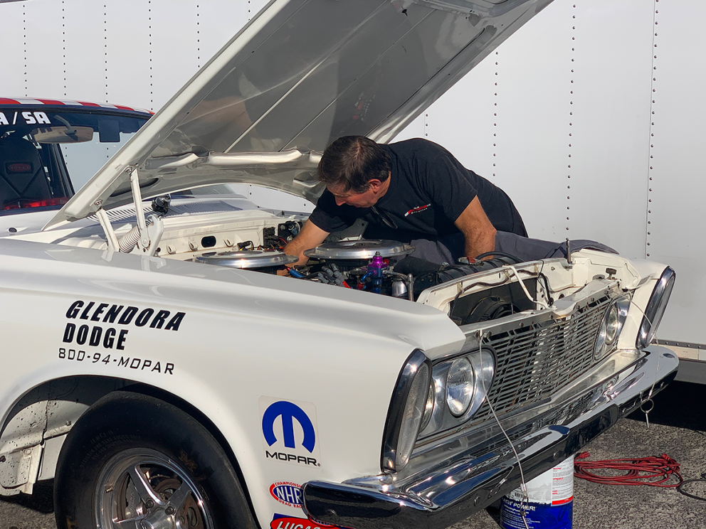 Man working under the hood of a vehicle