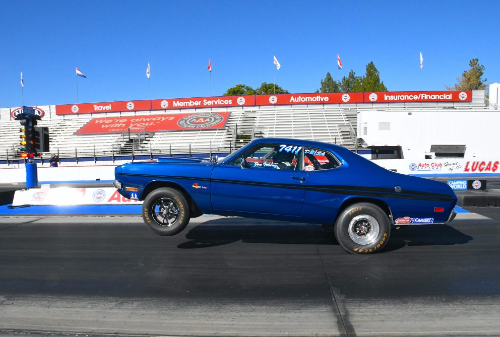 Car doing a wheelie off the line while drag racing