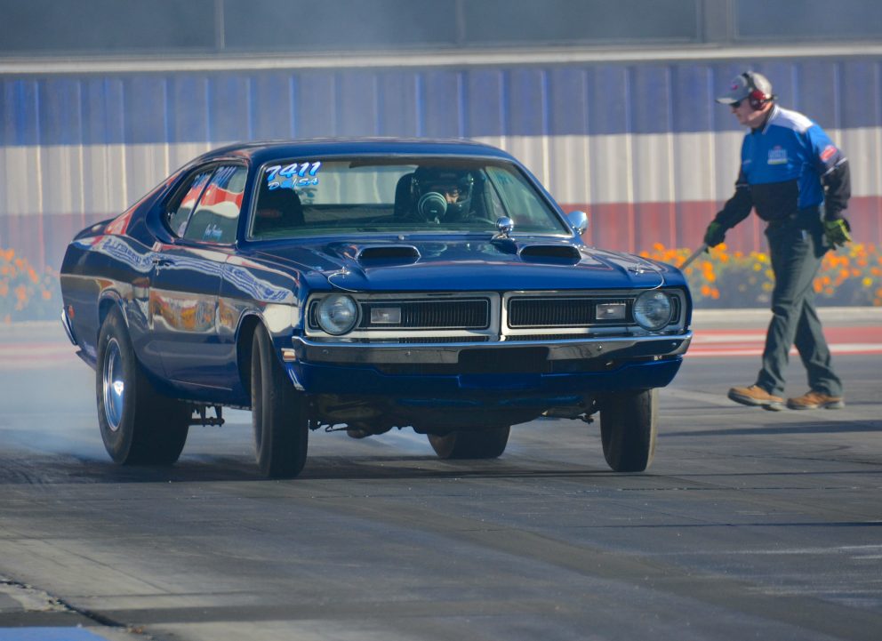 Man drag racing car