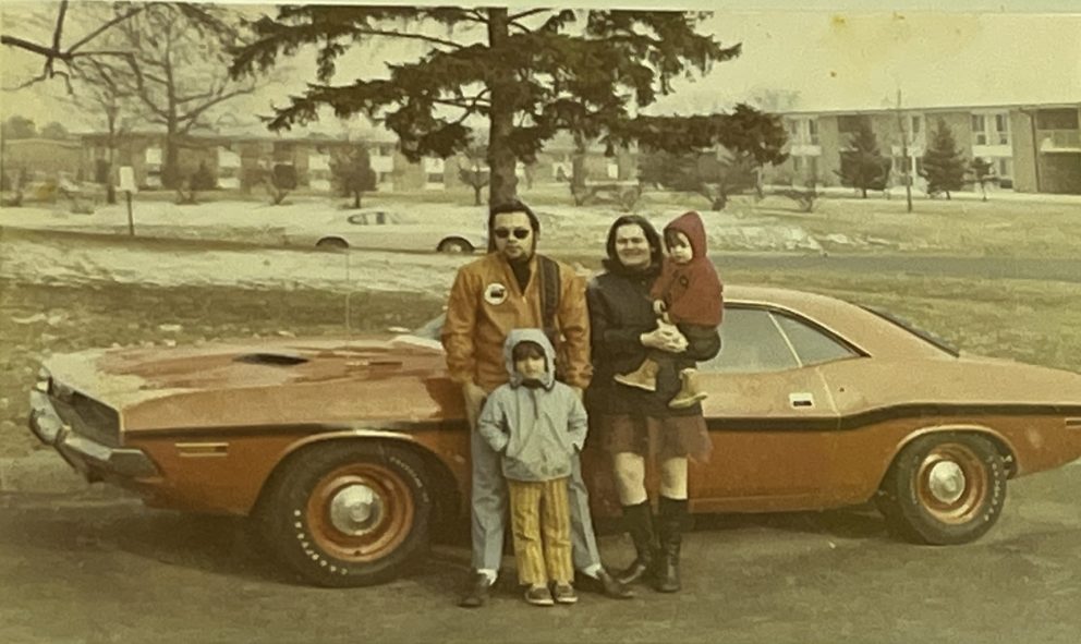 Vintage photo of family standing in front of their Dodge vehicle