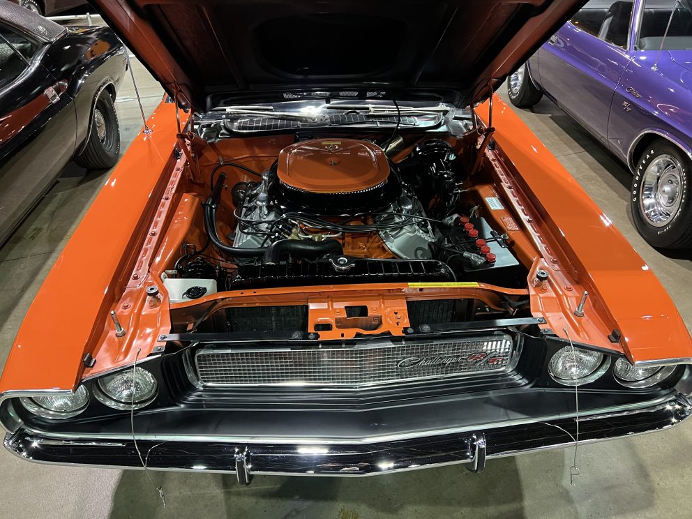 Dodge vehicle with hood open showing HEMI engine