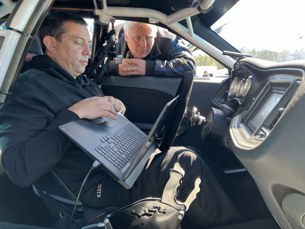 two men dialing in their race car