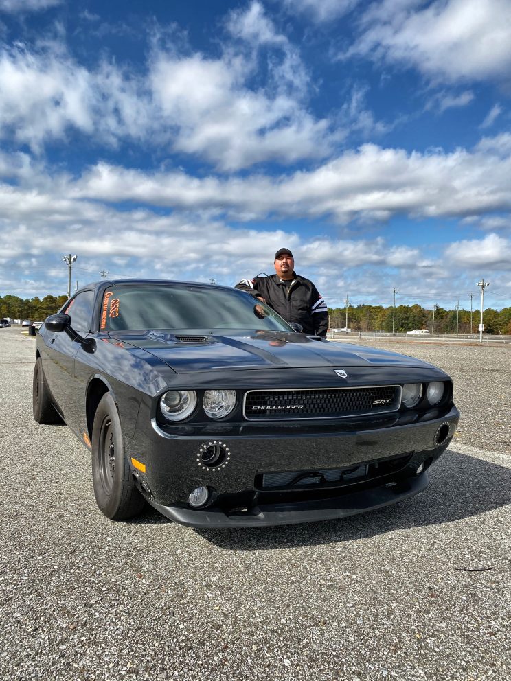 man standing next to his Challenger Hellcat