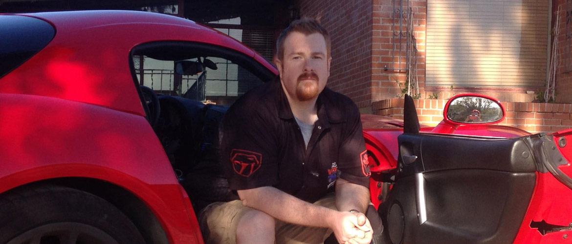 Man sitting in Red Dodge Viper