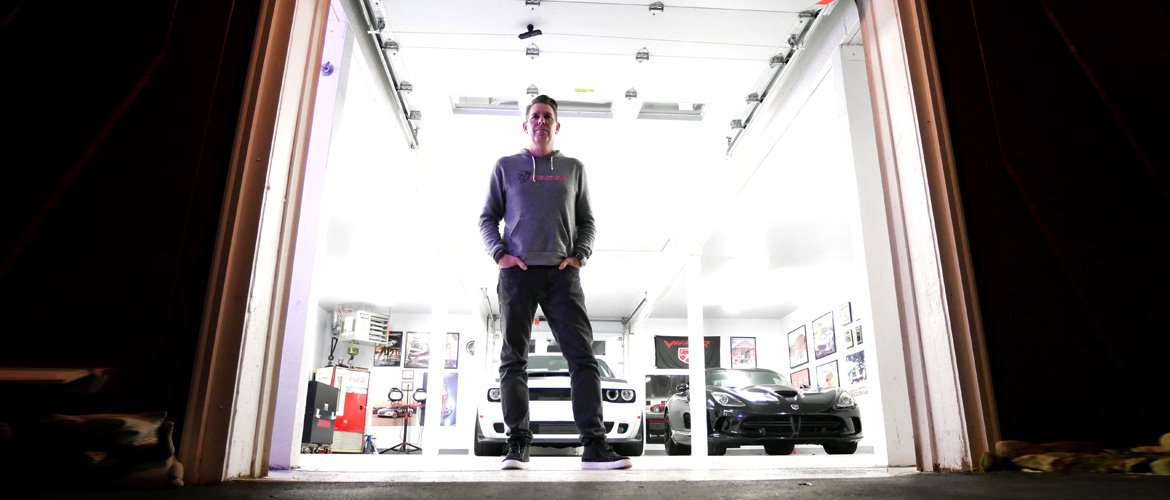 Man standing infront of his garage