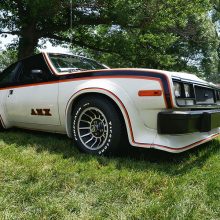 AMX older white car with black and orange detailing