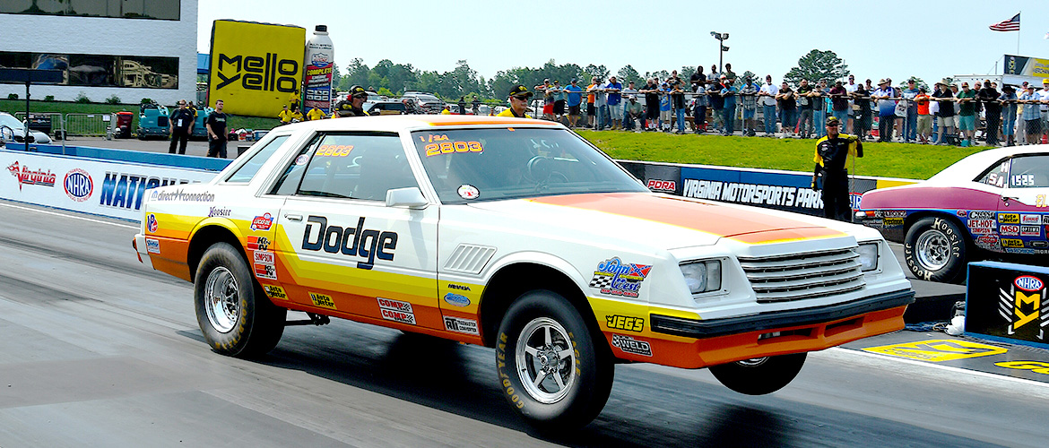 Old Dodge vehicle taking off at a race
