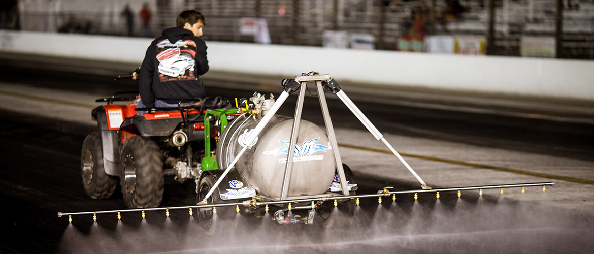 man spraying the racetrack