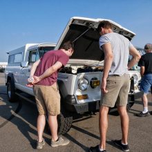 Young men examining the White older Challenger