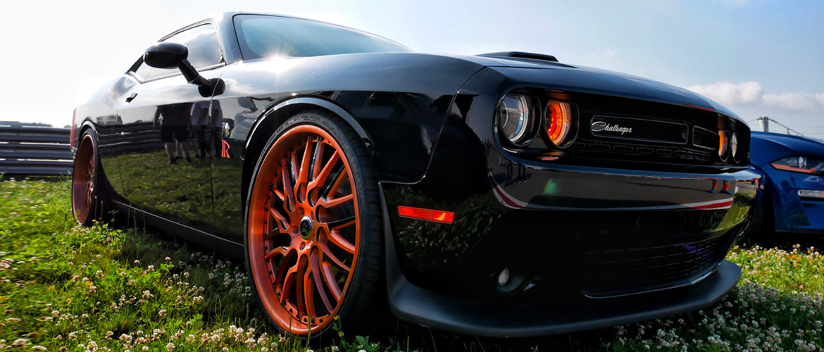 Black Dodge Challenger with orange detailing