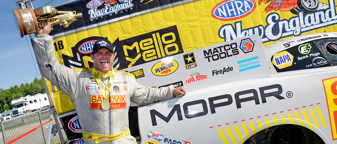 man posing with trophy after race