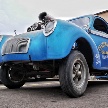 older blue car that has perfomance craftshift business information on its side