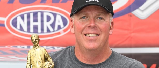 man posing with a trophy