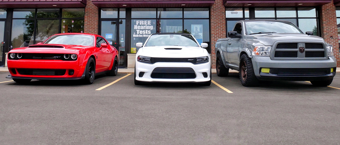 Three Dodge cars lined up