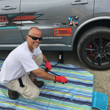 Steve fixing a flat tire on his Dodge Durango SRT