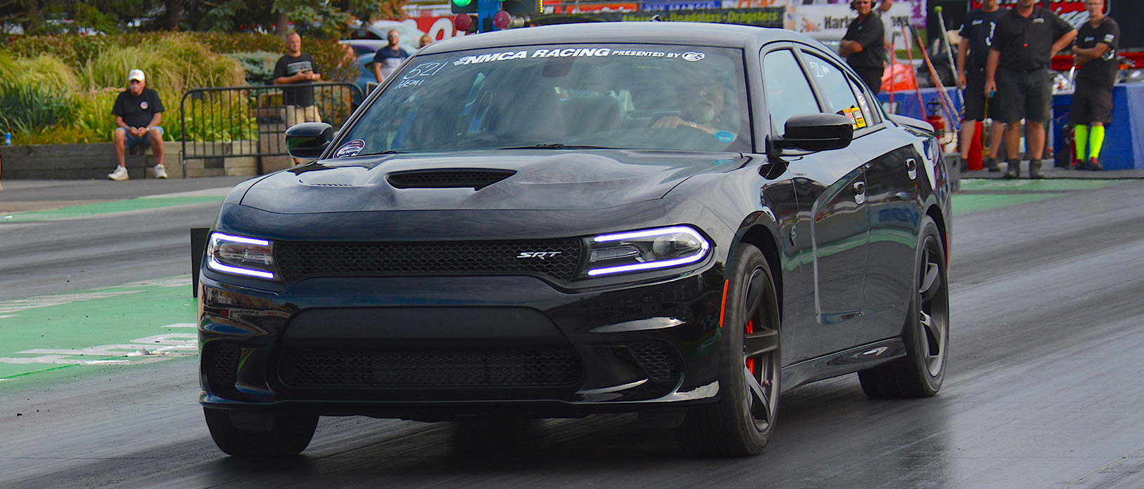 Black Dodge Charger Hellcat racing at NMCA World Street Finals