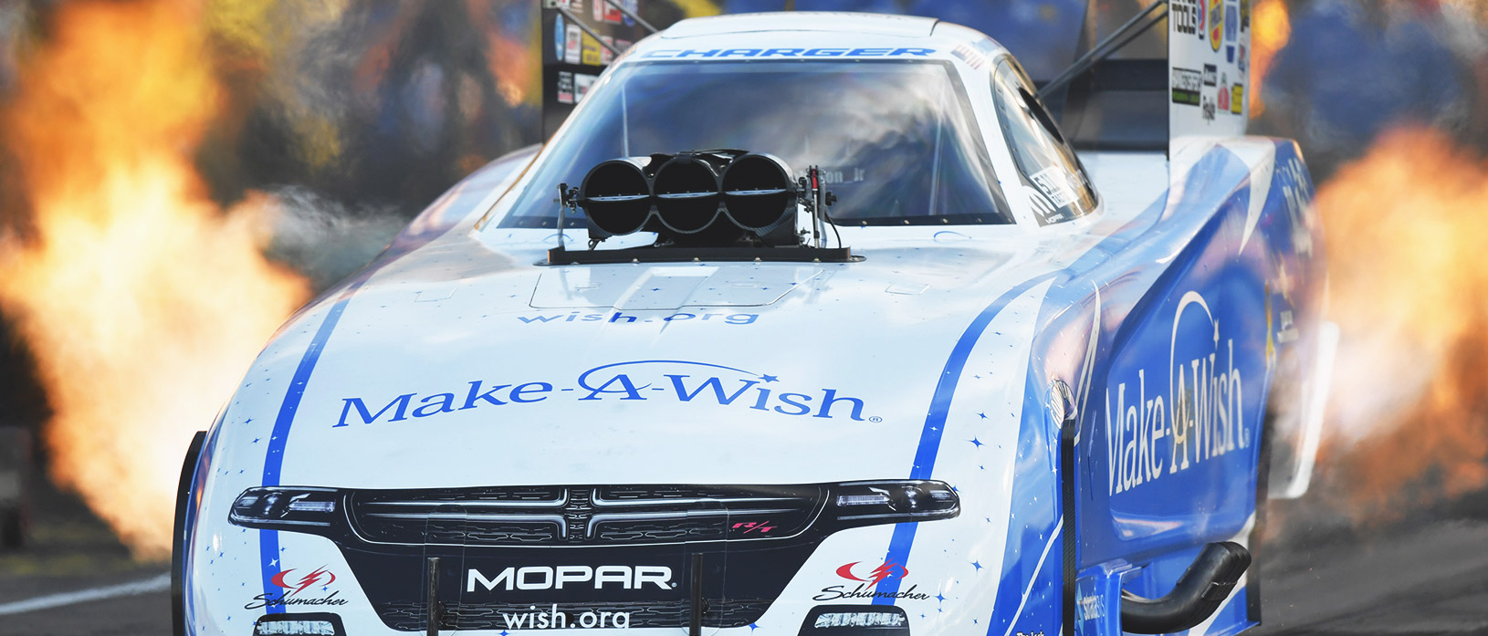 Tommy Johnson Jr.'s Make a Wish funny car racing down the track