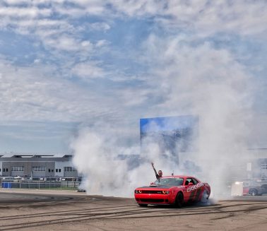 Richard Rawlings handing out of a Dodge Thrill Ride car