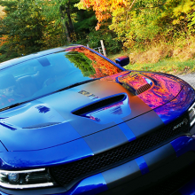 Blue 2018 Dodge Charger SRT Hellcat driving along tree-lined street