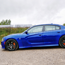 Blue 2018 Dodge Charger SRT Hellcat driving along tree-lined street