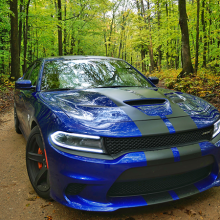 Blue 2018 Dodge Charger SRT Hellcat driving along tree-lined street