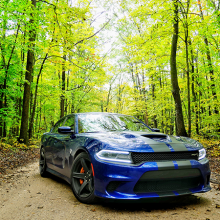 Blue 2018 Dodge Charger SRT Hellcat driving along tree-lined street