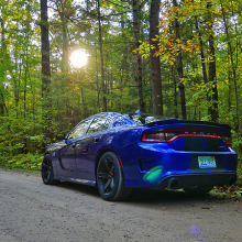 Blue 2018 Dodge Charger SRT Hellcat driving along tree-lined street