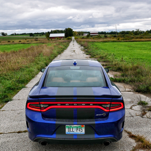Blue 2018 Dodge Charger SRT Hellcat parked on a rural farm